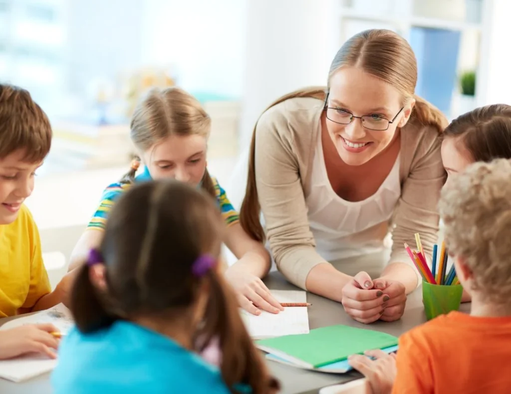 Children and an educator learning together around a table